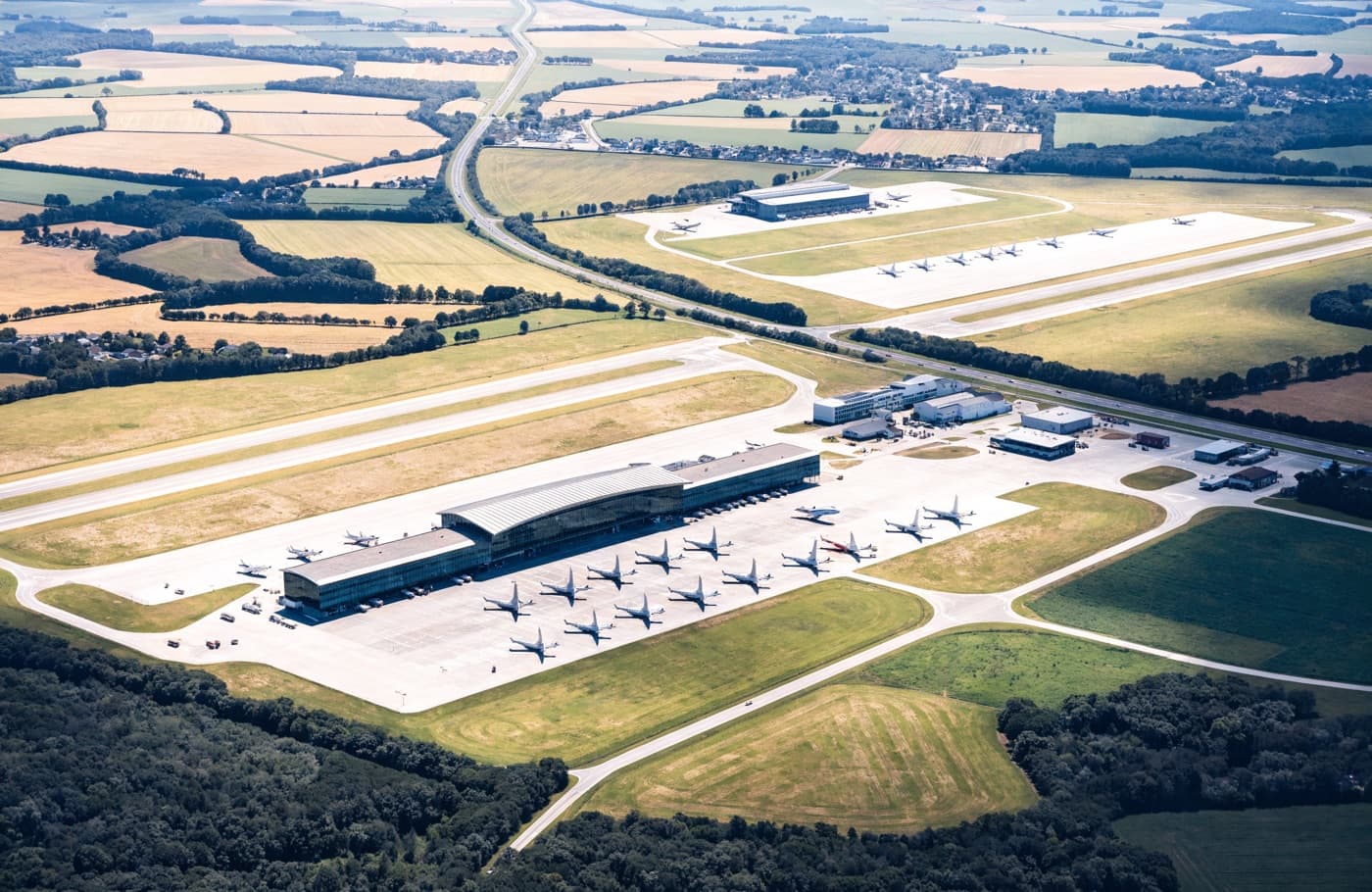Aerial view of an airport apron, terminal and runway