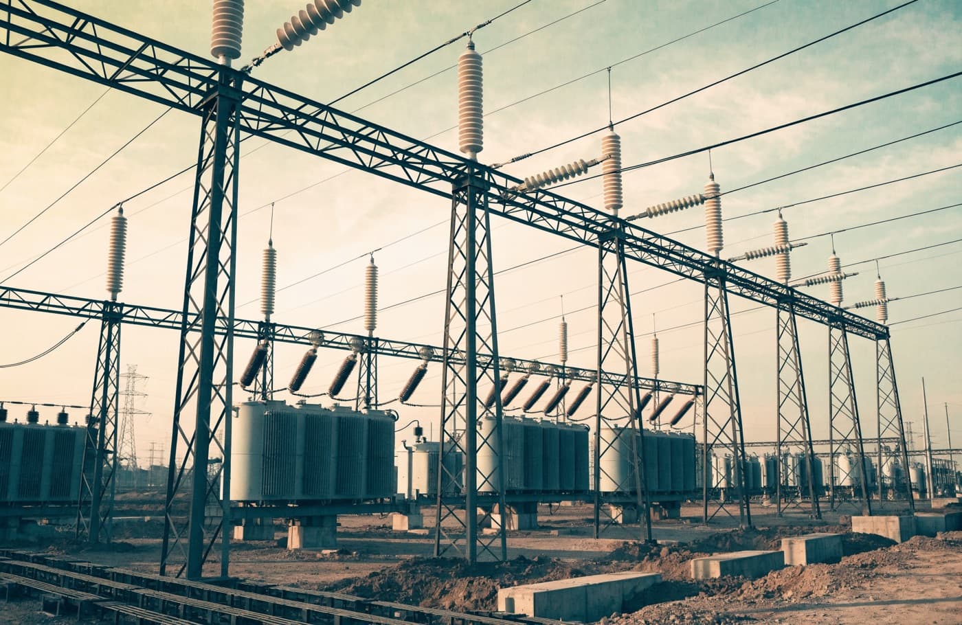 Electrical grid substation with steel gantries, transformers and insulators